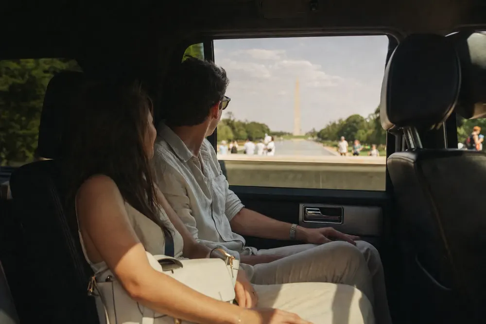 Guests sightseeing through the window of a Skyhawk Limousine vehicle with the Washington Monument in view