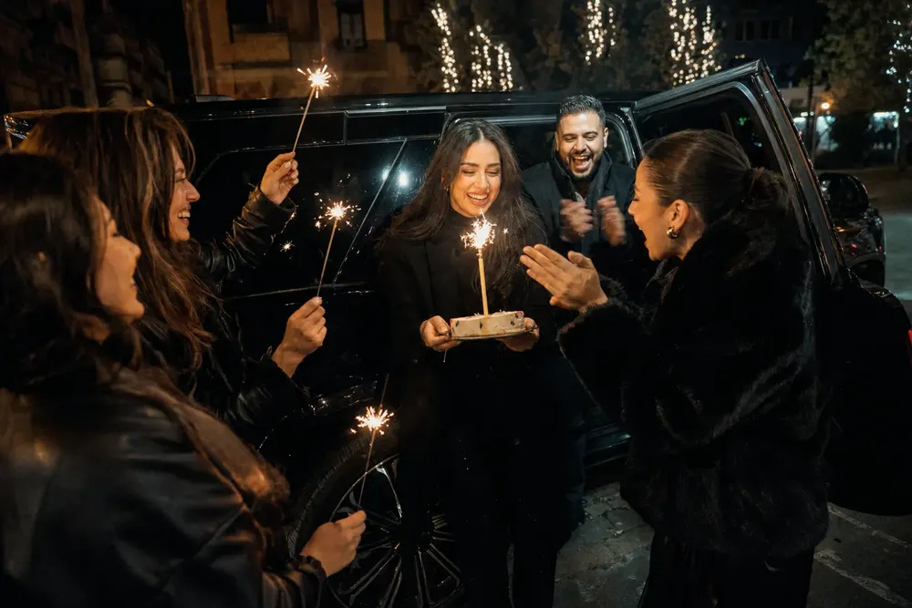 Friends toasting champagne with balloons inside a Skyhawk Limousine limousine on a birthday night out in DC