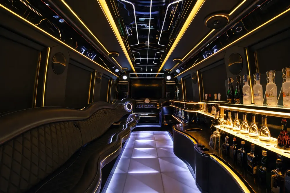 Party bus onboard bar with backlit bottle display and LED dance floor
