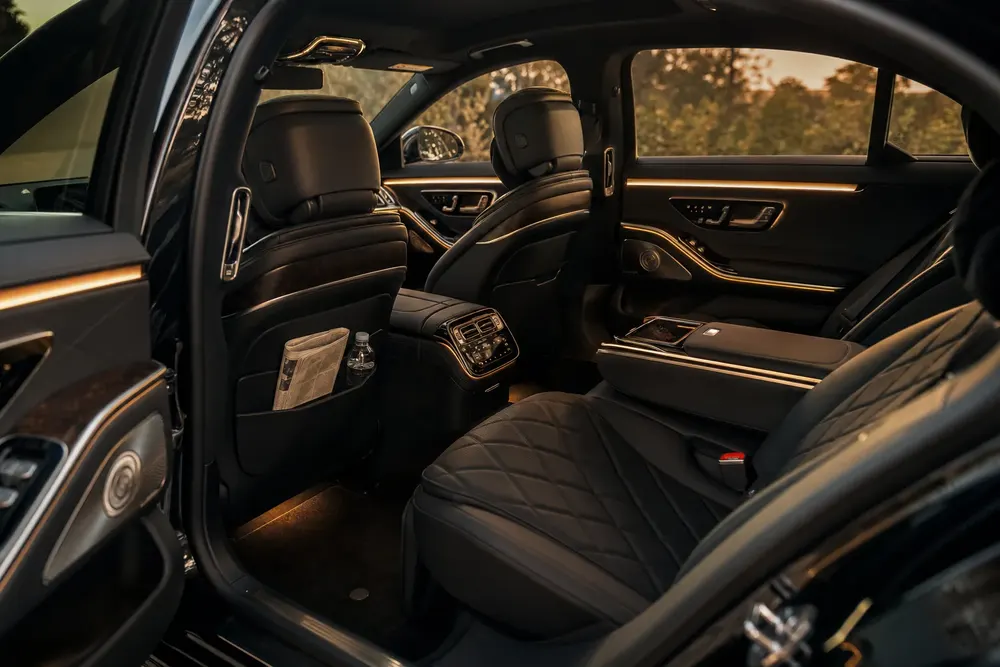 Quiet, climate-controlled rear cabin of a Mercedes-Benz S580 for a grieving family