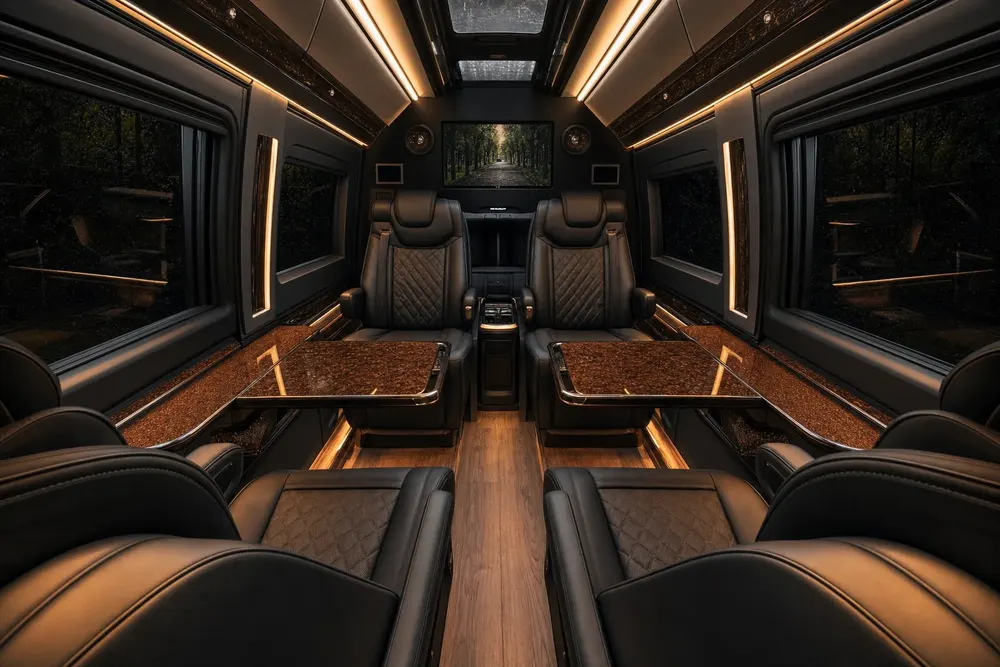 Interior of a black Mercedes-Benz Sprinter with captain chairs and ambient lighting for a DMV brewery tour