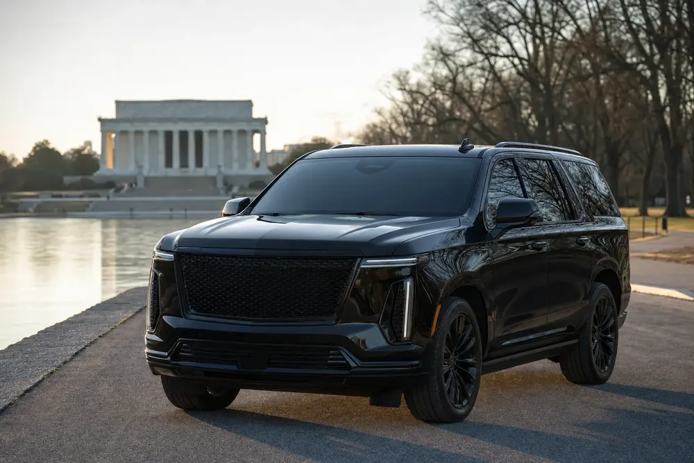 Black Cadillac Escalade beside the Lincoln Memorial reflecting pool in Washington, DC